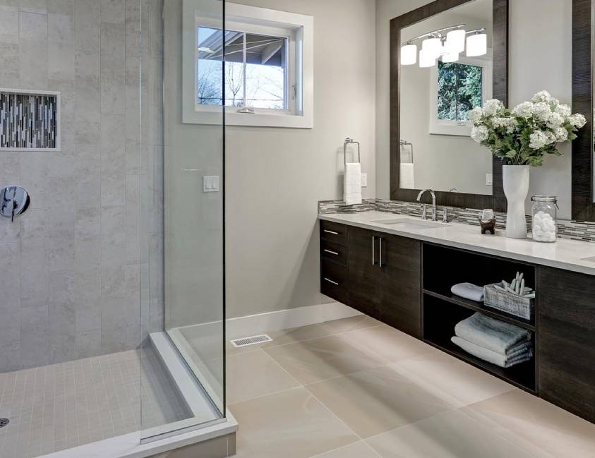 Modern bathroom with walk-in shower, double vanity, and decorative flowers Modern bathroom with walk-in shower, double vanity, and decorative flowers