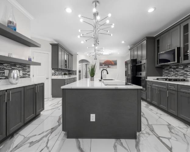 Modern kitchen interior with dark cabinets, white countertops, and stylish light fixture Modern kitchen interior with dark cabinets, white countertops, and stylish light fixture